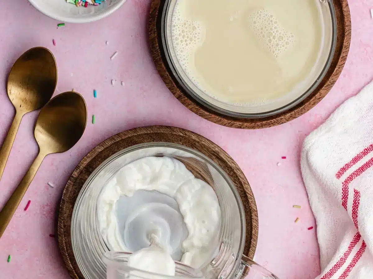 Hot, sweet, and creamy beverage added to mugs.