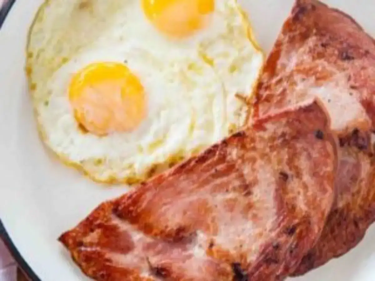 Plate of grilled ham and eggs