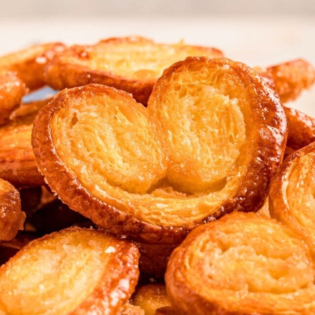 Baked cookies piled on plate.
