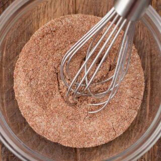 a bunch of spices mixed in a bowl with a whisk