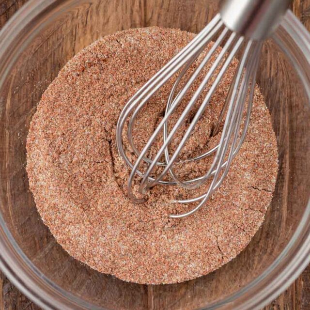 a bunch of spices mixed in a bowl with a whisk