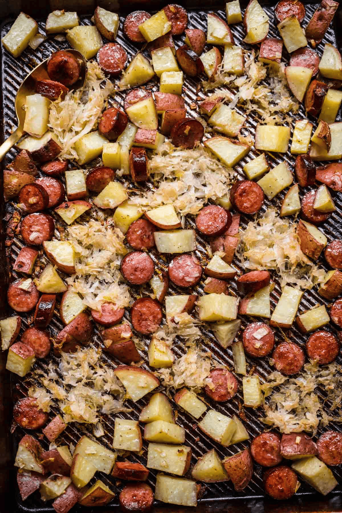 sheet pan with sausage, potatoes, sauerkraut
