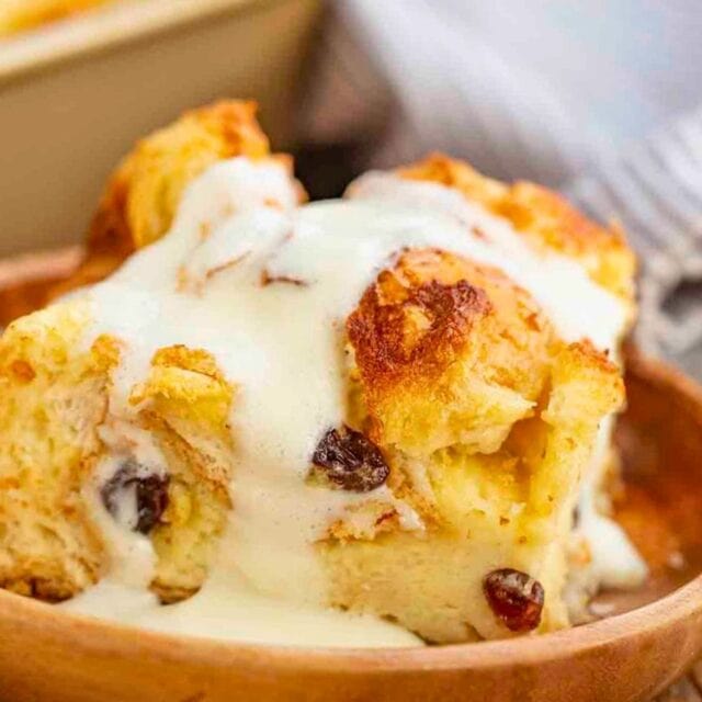 A Slice of baked pudding with Raisins and Vanilla Sauce