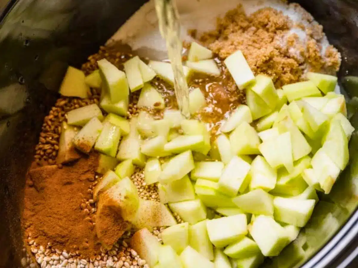 Water pouring onto apples and spices