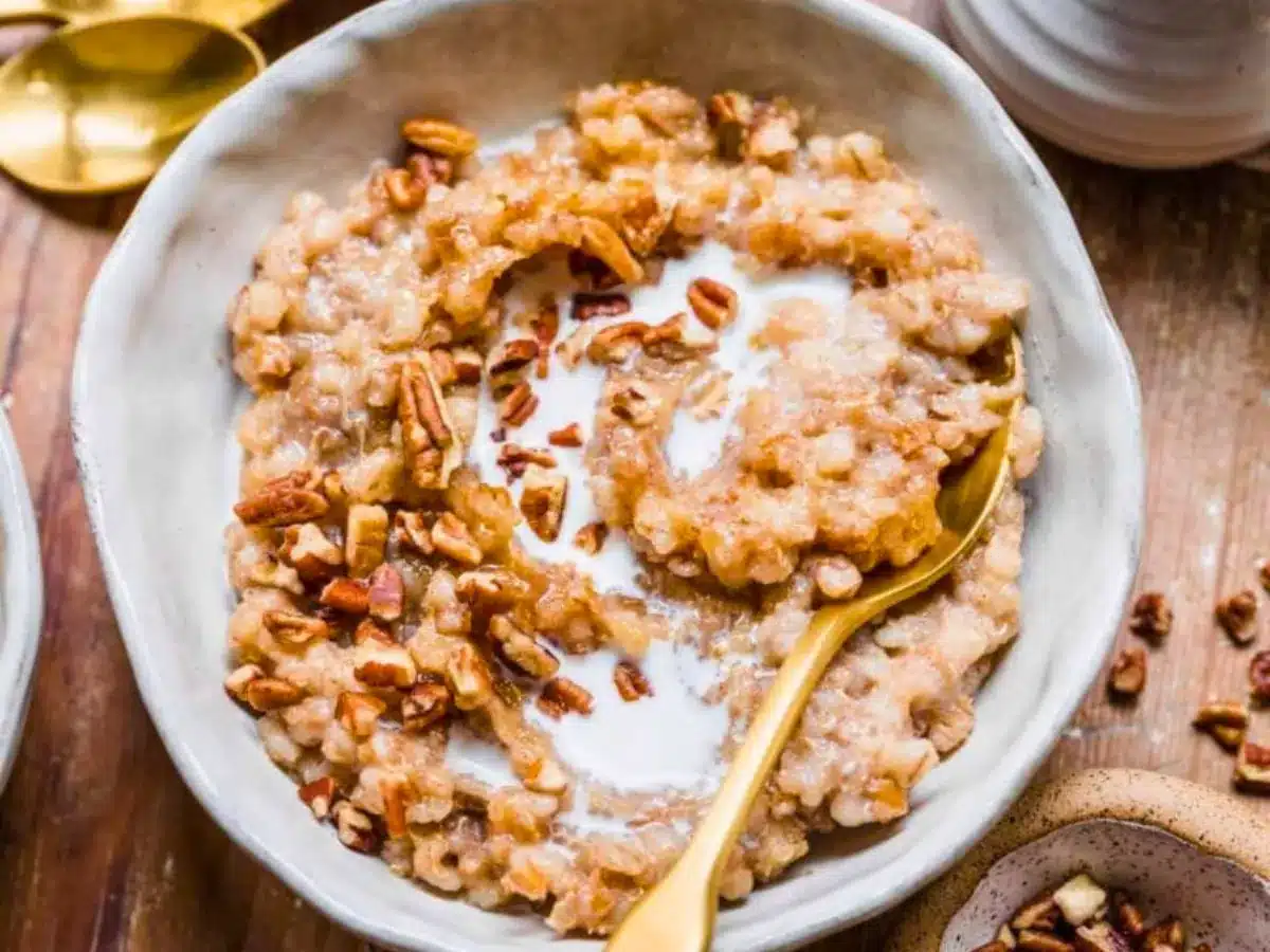 Bowl with grains, nuts, and milk with spoon