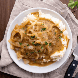 Top view of steak and onions with gravy