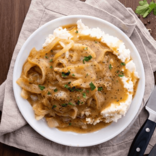 Top view of steak and onions with gravy