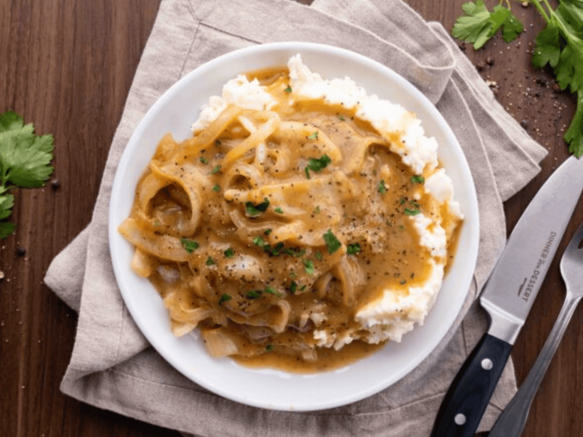 Top view of steak and onions with gravy
