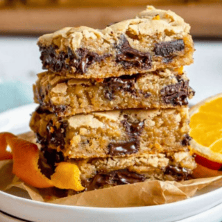Stack of blondies on a plate with orange peel