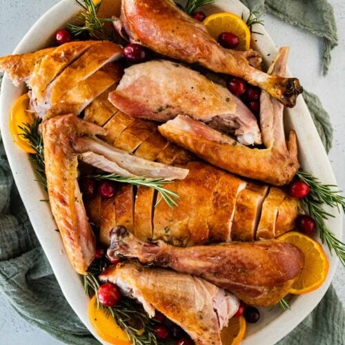 Dry Brined Turkey sliced on roasting dish