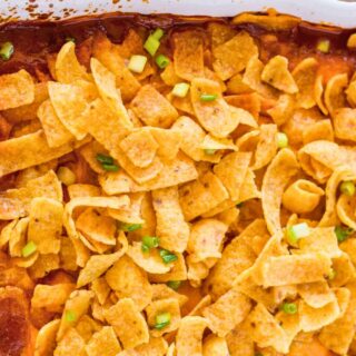 Top down view of baked Frito Pie in white baking dish.