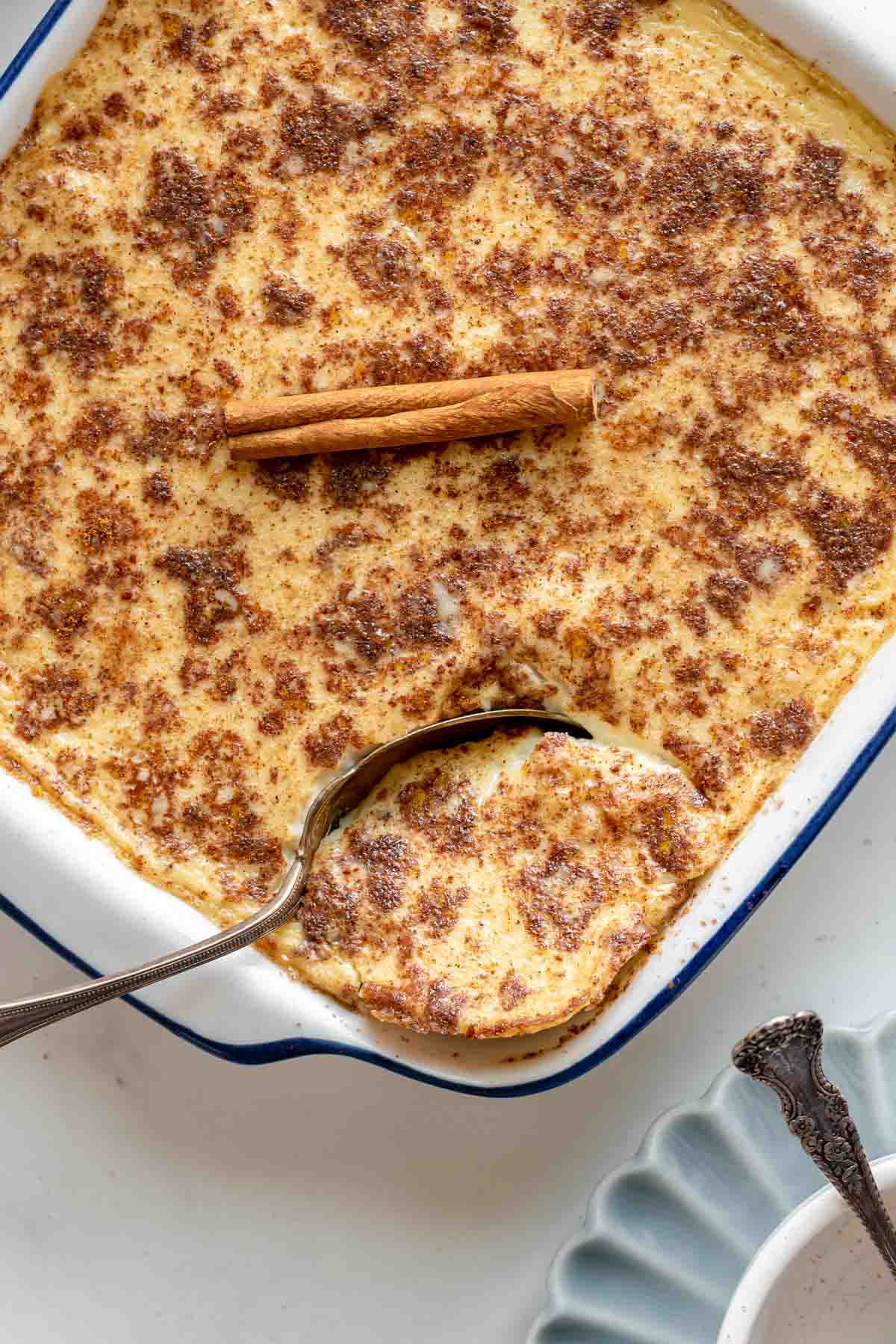 Baked Rice Pudding cooked pudding in a baking dish with spoon
