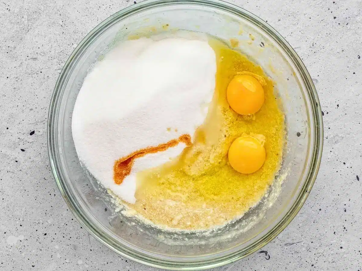 eggs, sugar, and vanilla in a glass bowl