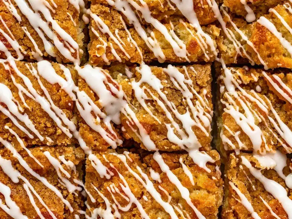 top view of moist buttery treat cut into rectangles with icing drizzled on top
