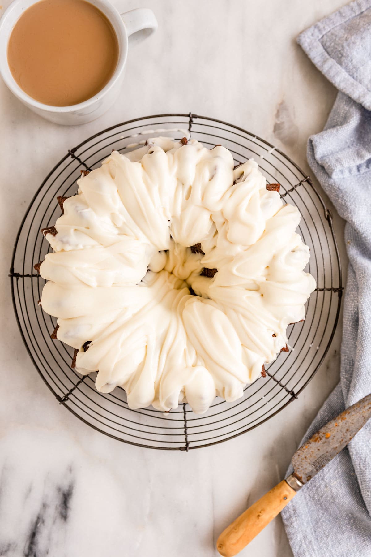 Banana Bundt Cake frosted cake on wire cooling rack, view from above