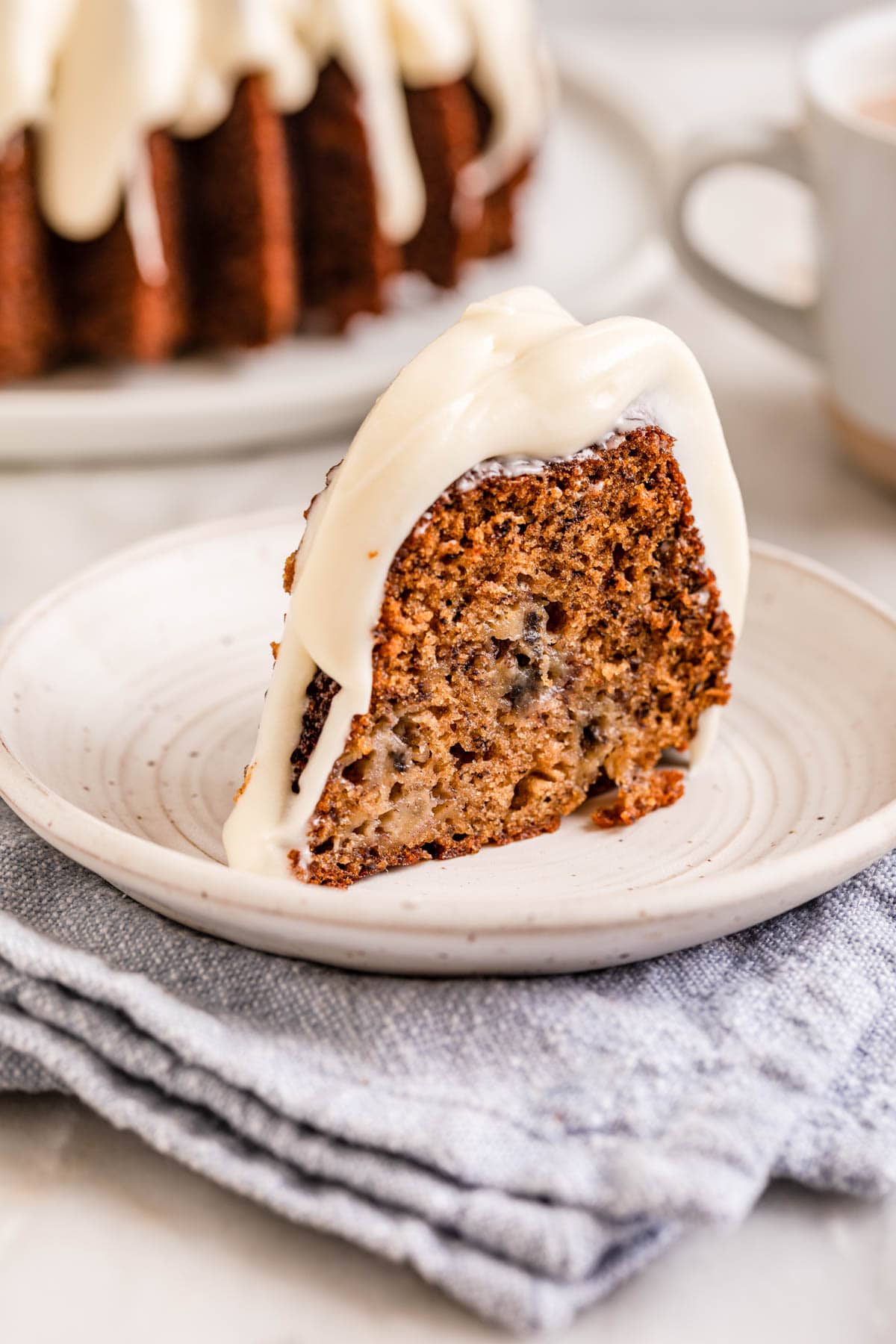 Banana Bundt Cake baked and frosted cake slice on plate