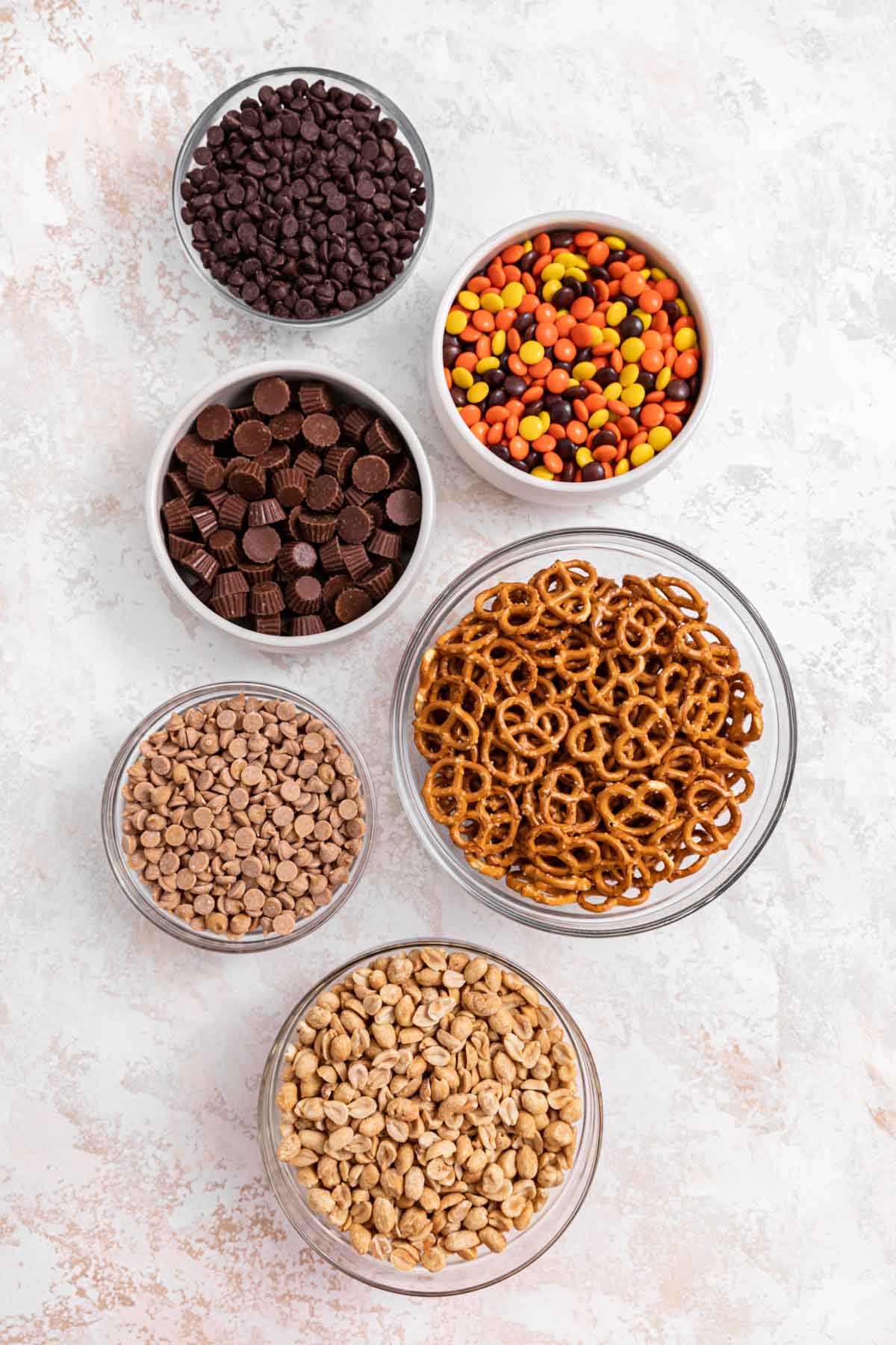 Chocolate Peanut Butter Trail Mix ingredients in separate bowls