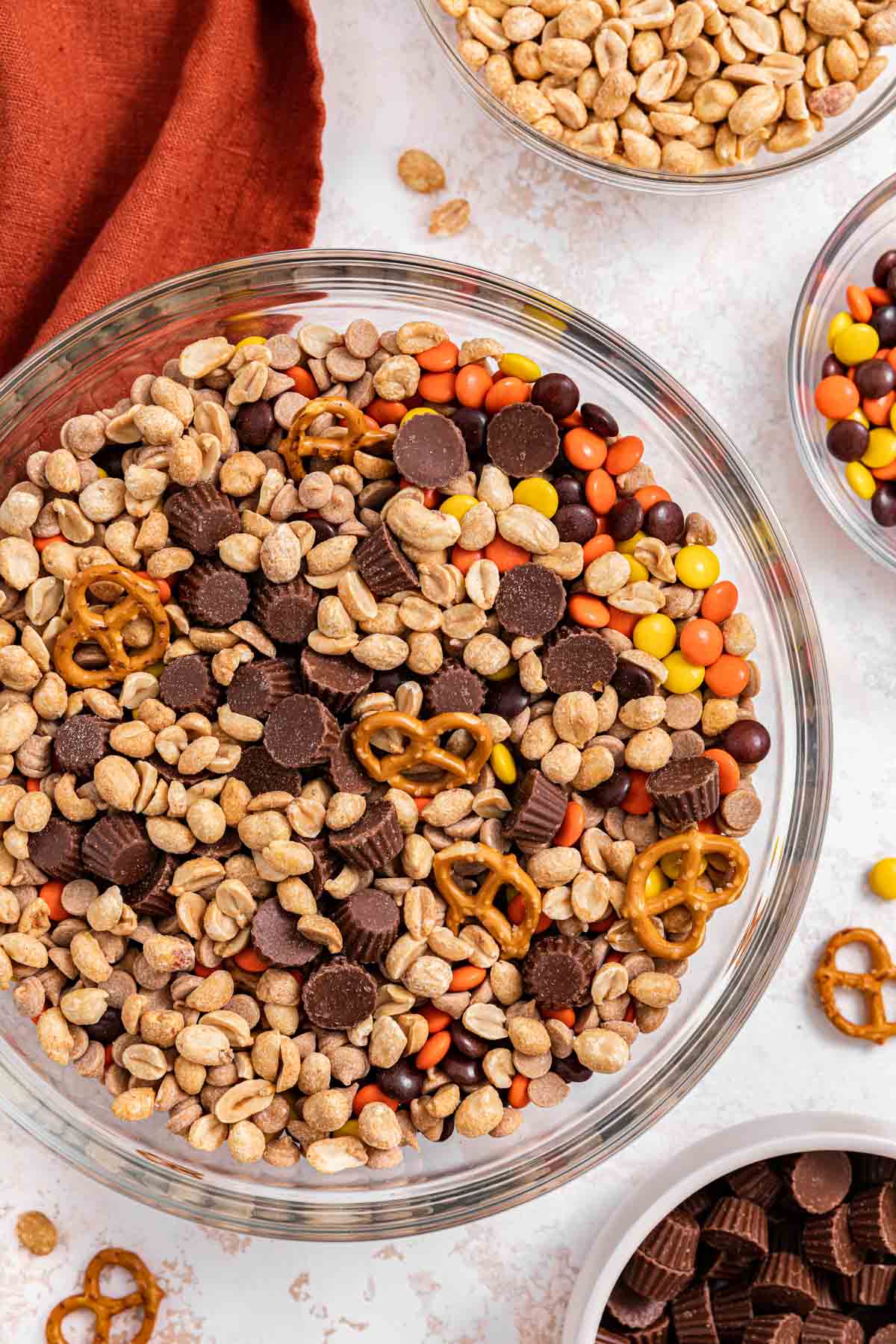 Chocolate Peanut Butter Trail Mix ingredients in large bowl half mixed mixing