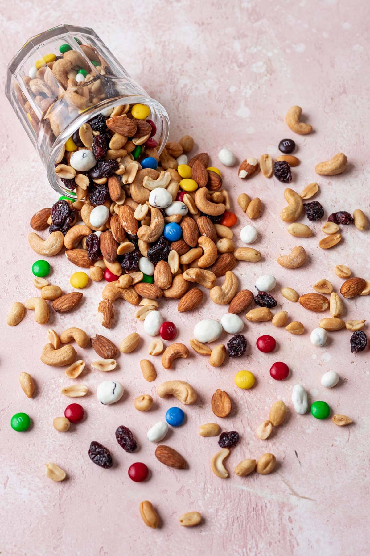 Classic Trail Mix combined spilling out of glass jar, top down view
