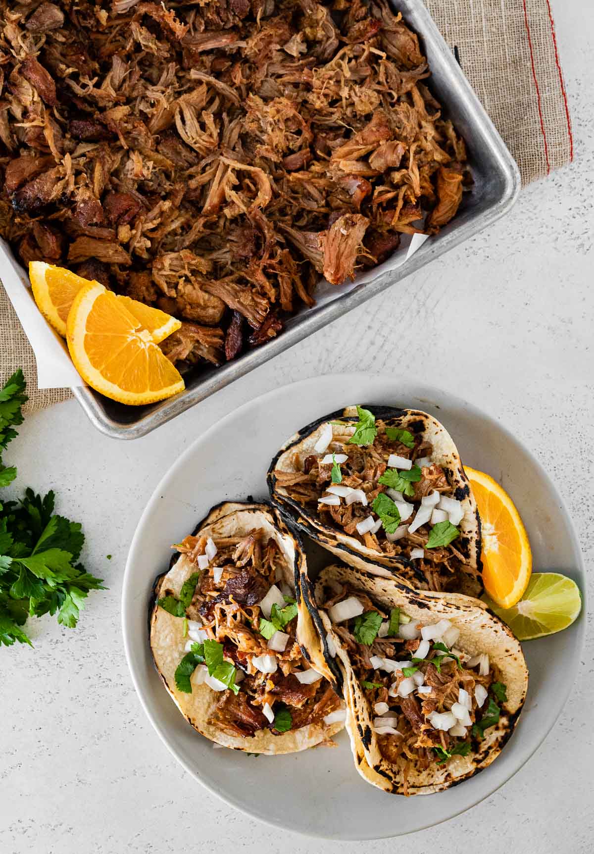 Instant Pot Pork Carnitas in baking dish and on plated in three soft tacos