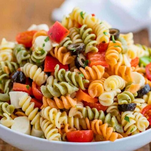 Tri-color pasta piled in a white bowl