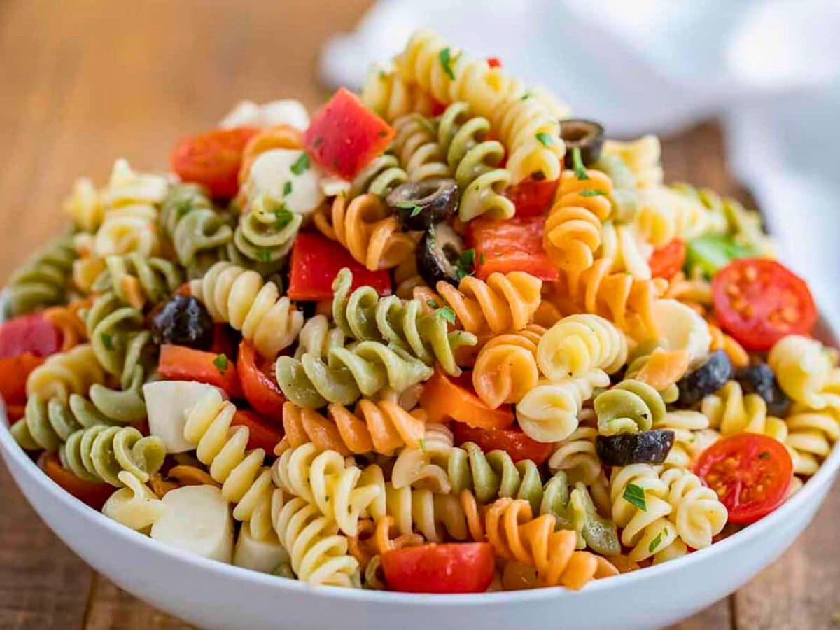 Tri-color pasta piled in a white bowl