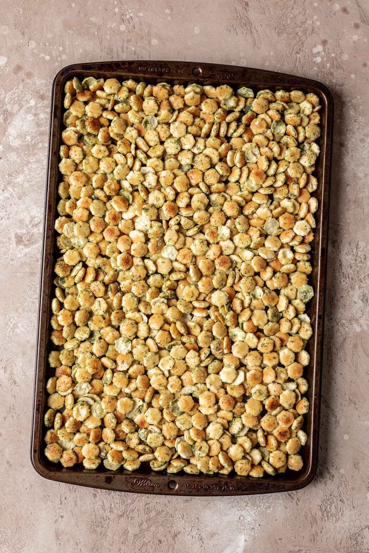 Ranch Oyster Crackers seasoned before baking on a baking sheet