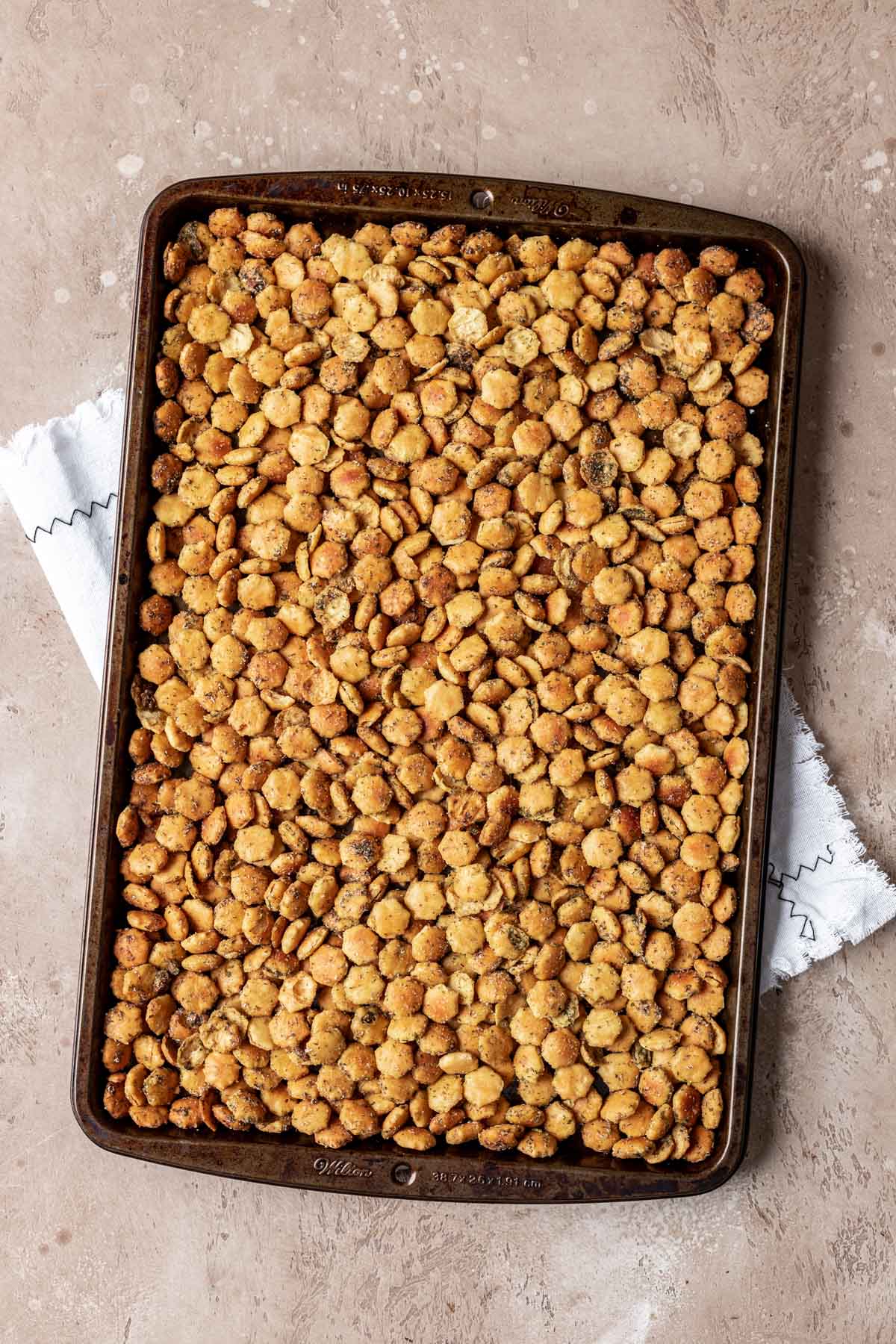 Ranch Oyster Crackers seasoned and baked on a baking sheet