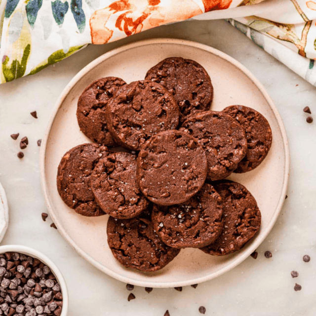circle cocoa biscuit treats stacked on a plate