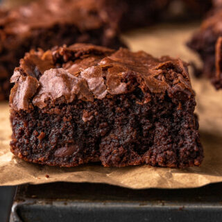 Super Rich Chocolate Brownies close up on a baked brownie on parchment paper