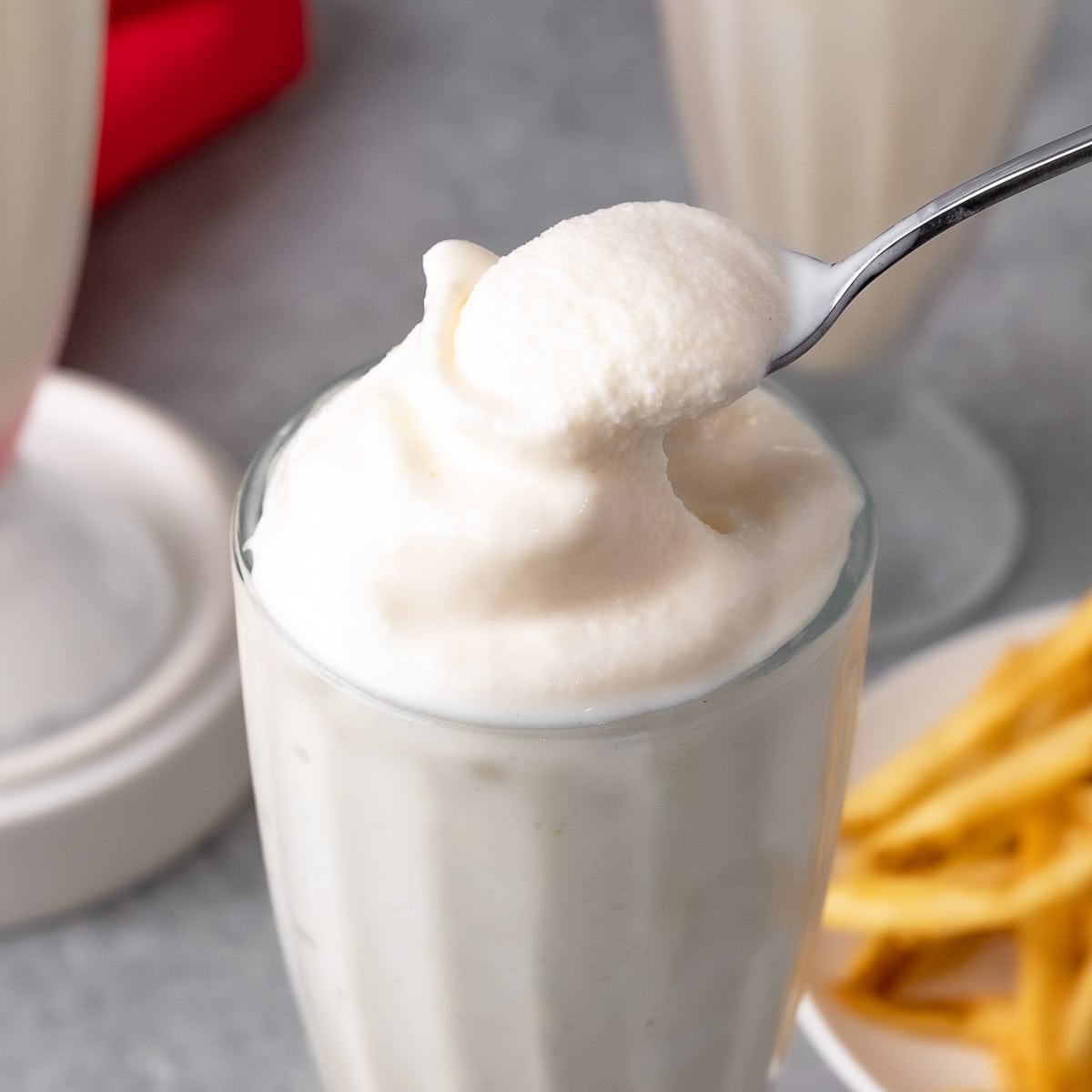 Wendys Vanilla Frosty in a milkshake glass with a spoon