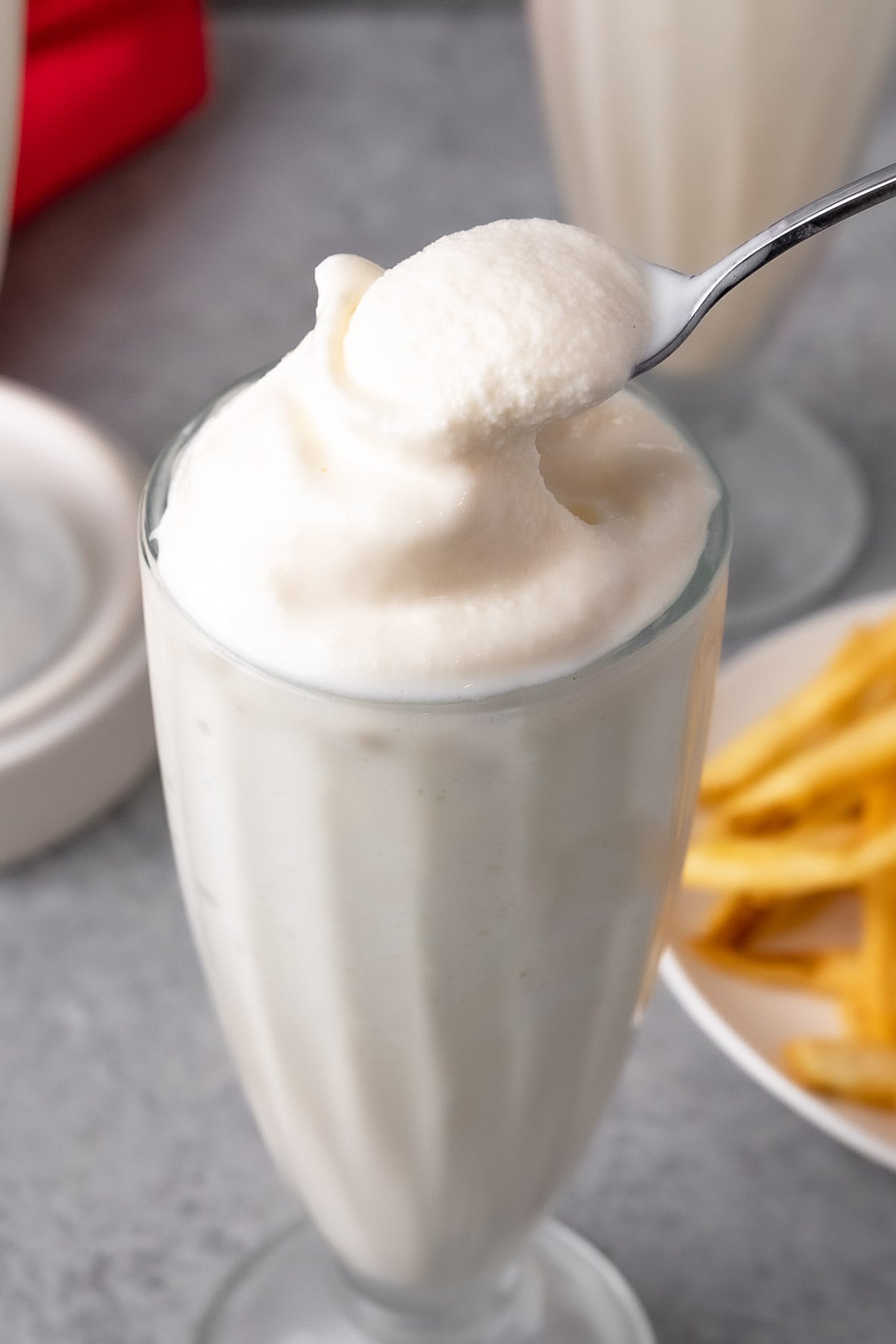 Wendys Vanilla Frosty in a milkshake glass with a spoon