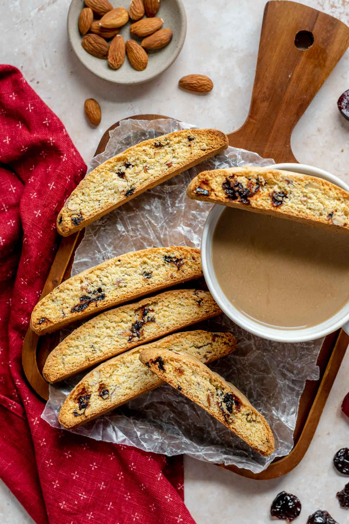 Cherry Almond Biscotti baked cookies resting on coffee cup and serving tray