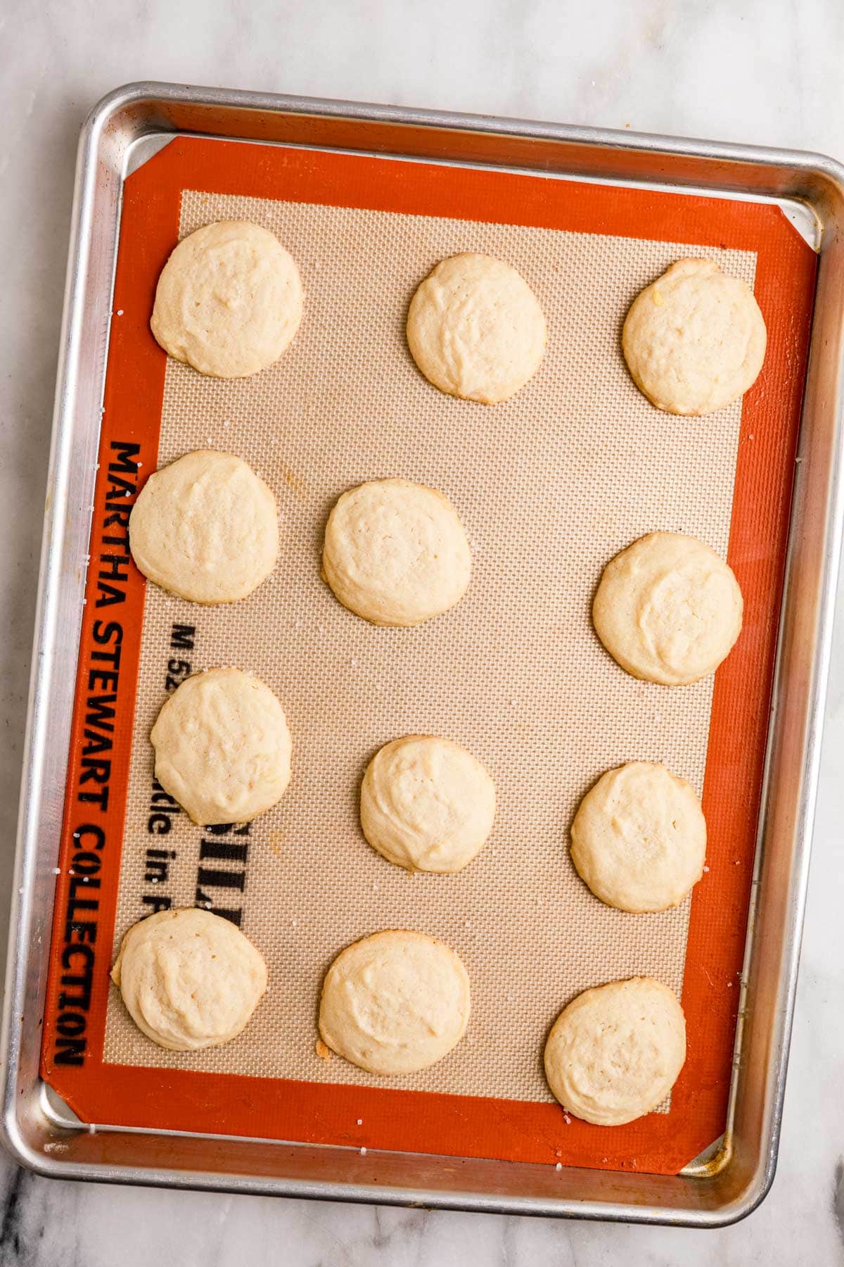 Amish Sugar Cookies baked cookies on silpat mat on baking sheet