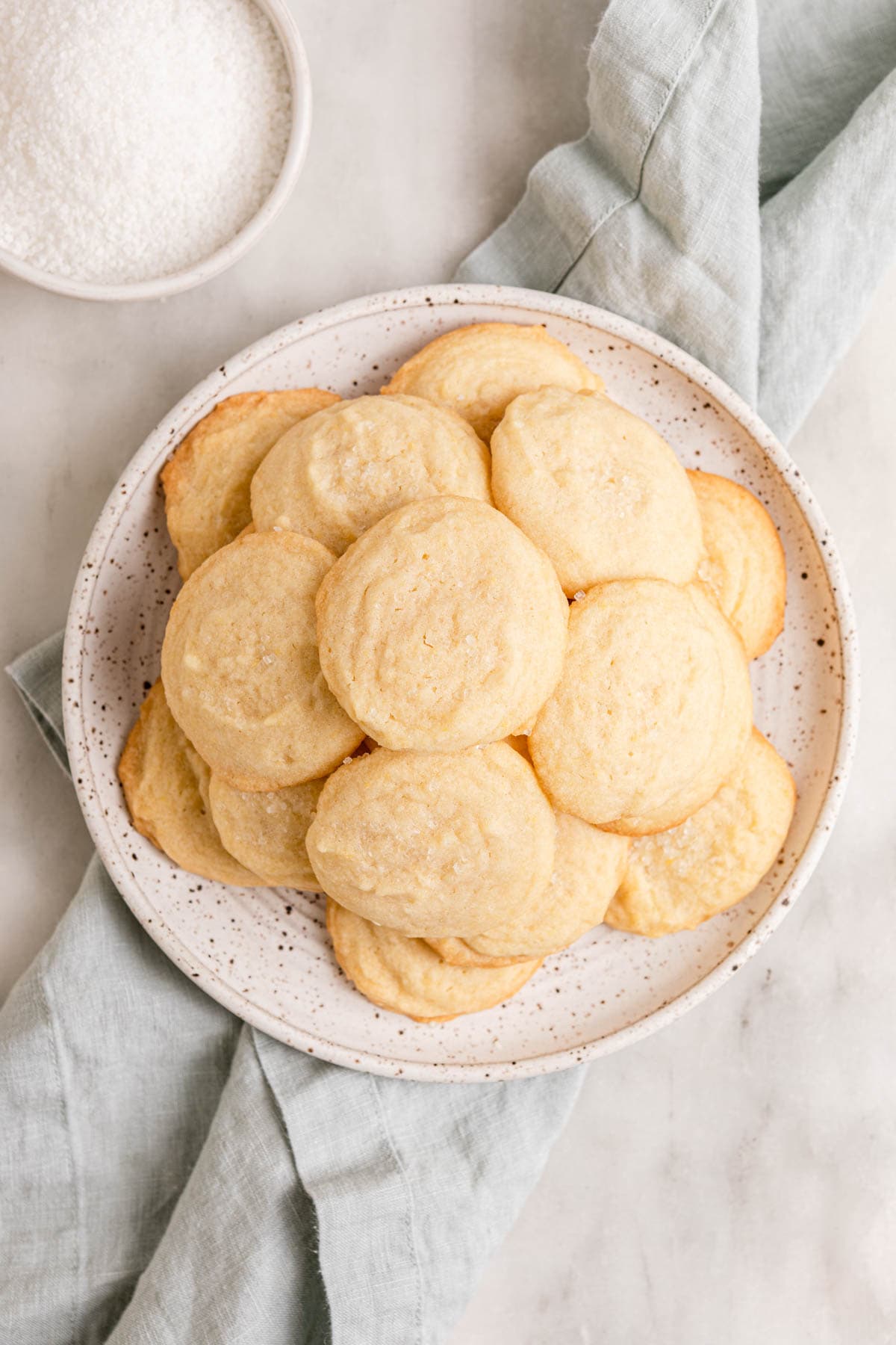 Amish Sugar Cookies baked cookies piled on plate, top down view