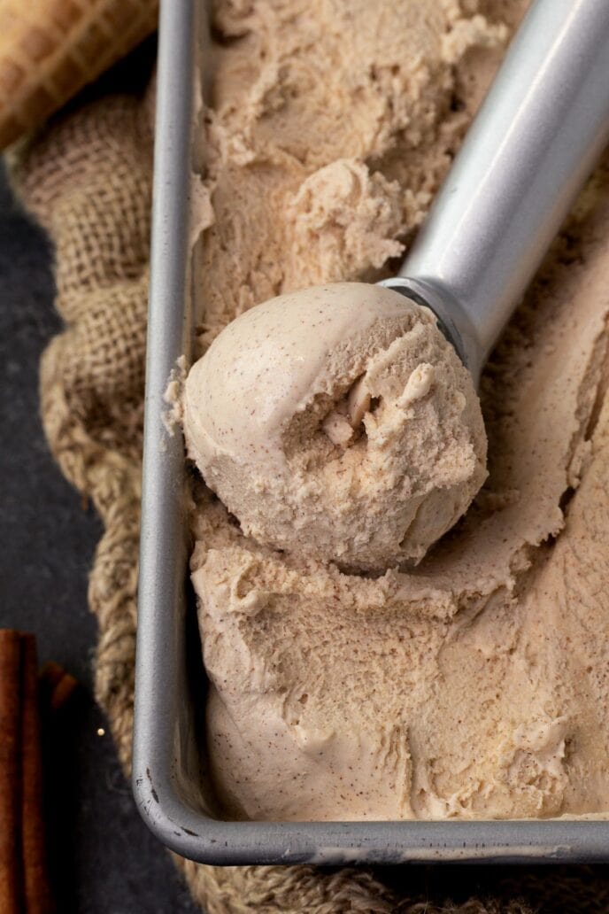 Cinnamon Ice Cream frozen in container being scooped up