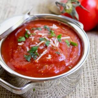 a pot of sauce with garnishes