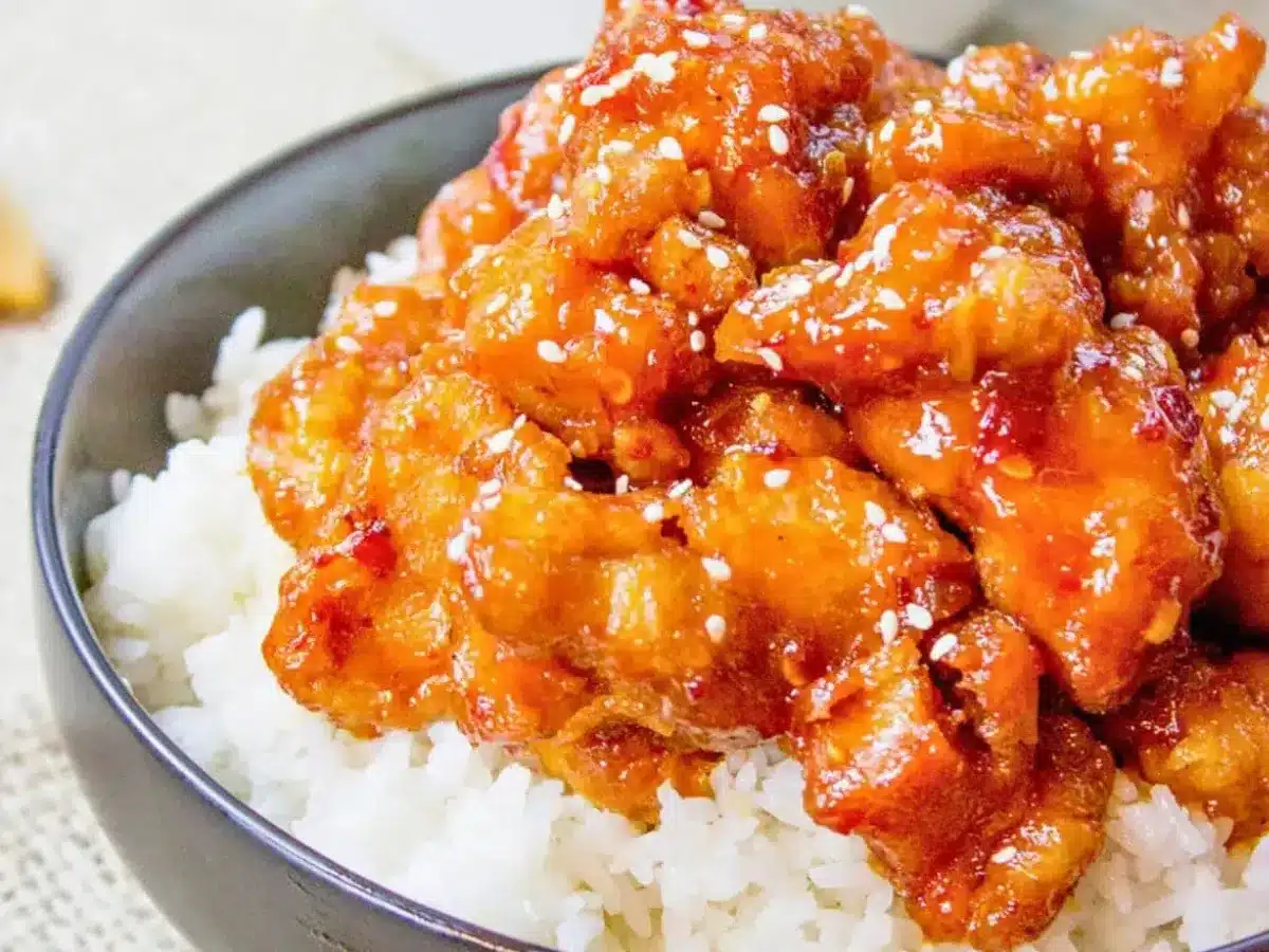 Side view of chicken in bowl served over rice