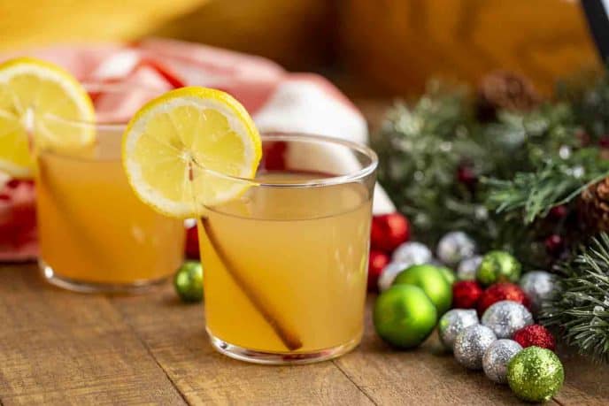 Two cocktails with lemon wedge and holiday decor