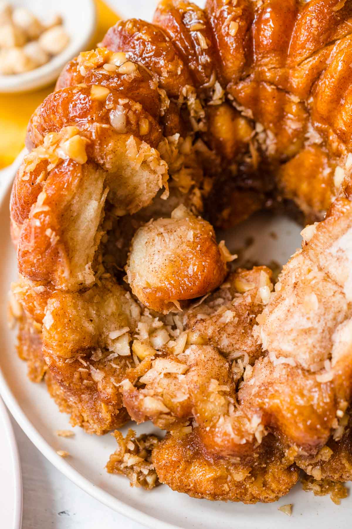 Hawaiian Monkey Bread finished on plate with pieces missing, top down view close up