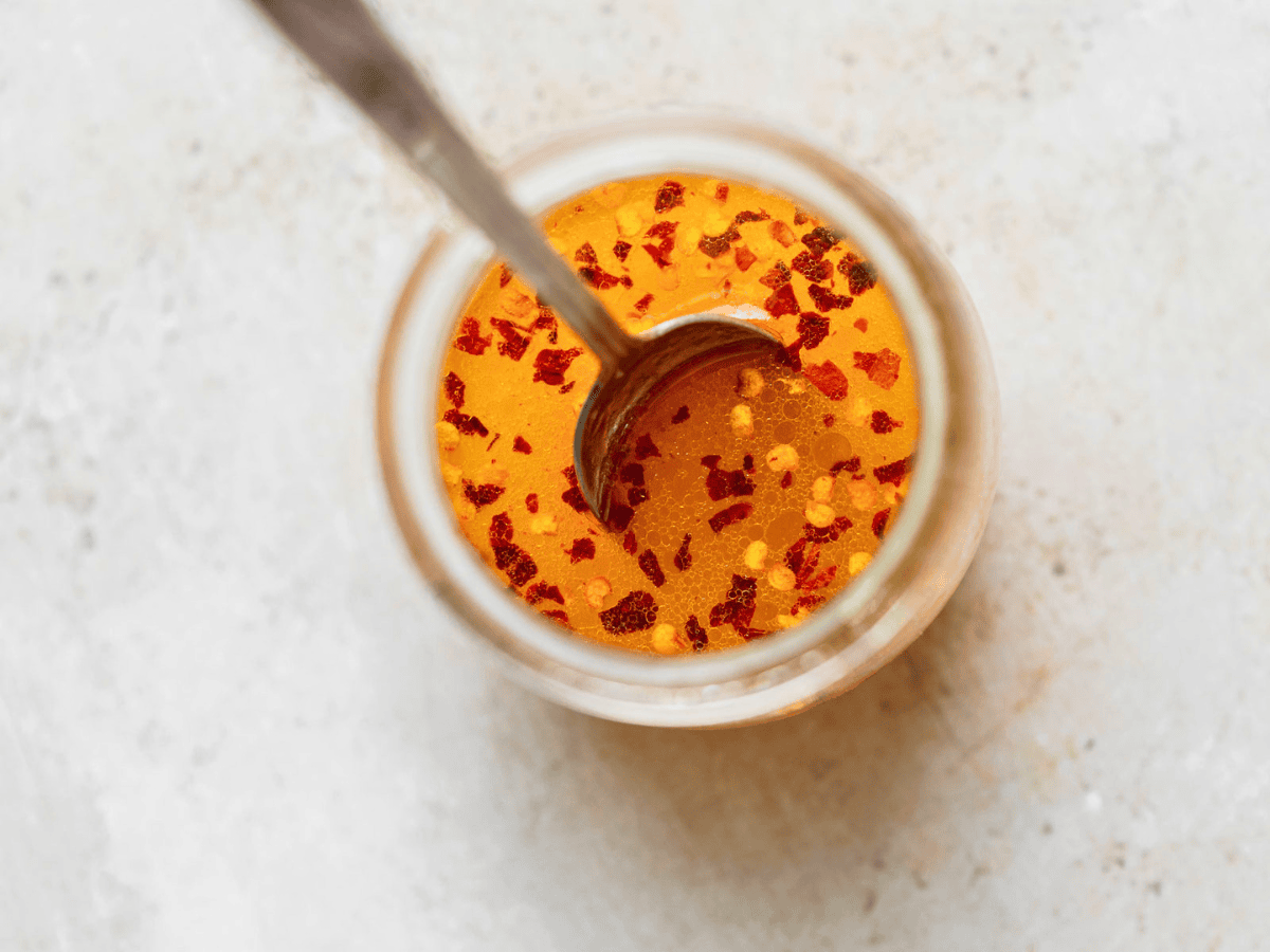 dressing in a glass jar with a spoon