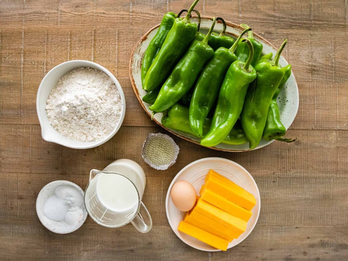 Ingredients in separate prep dishes and raw Chiles piled on platter