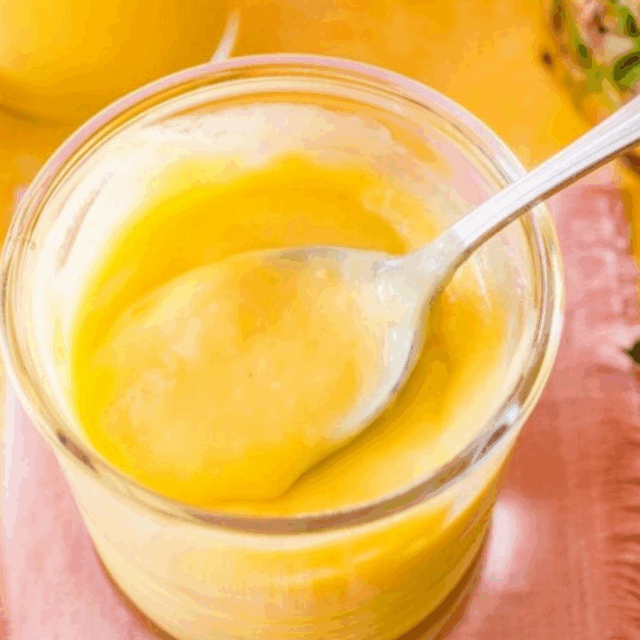 fruit curd in jar with a spoon