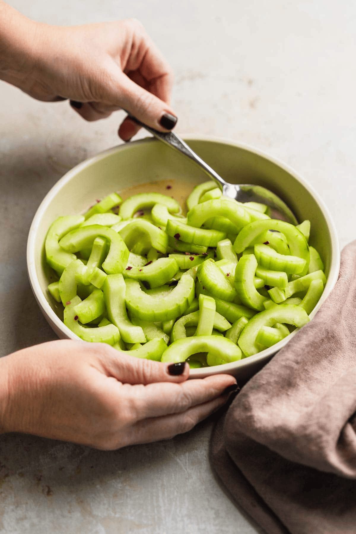 Mixing Cucumber Salad