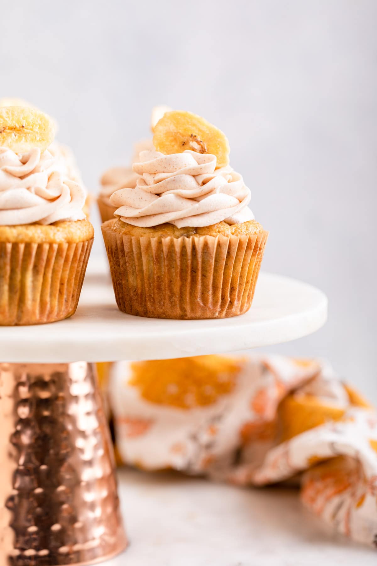 Banana Cupcakes frosted cupcakes on cake plate, side view