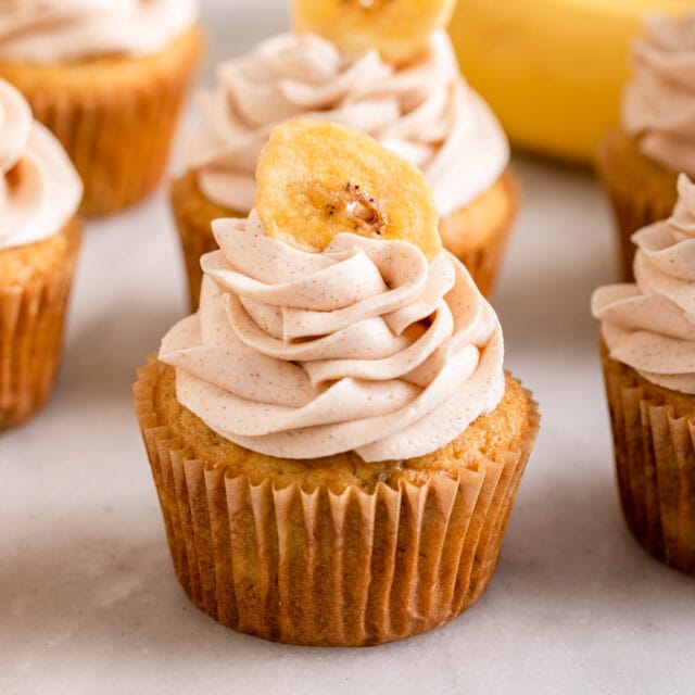 Banana Cupcakes frosted and lined up on white background