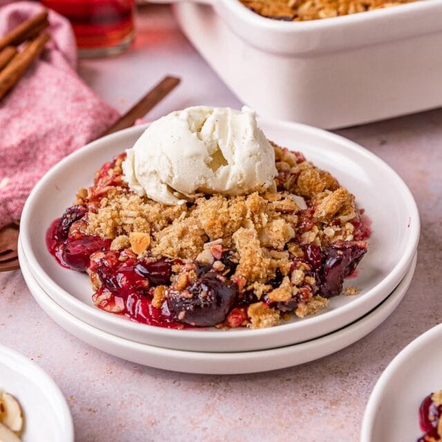 Cherry Crisp prepared and plated with scoop of vanilla ice cream on top