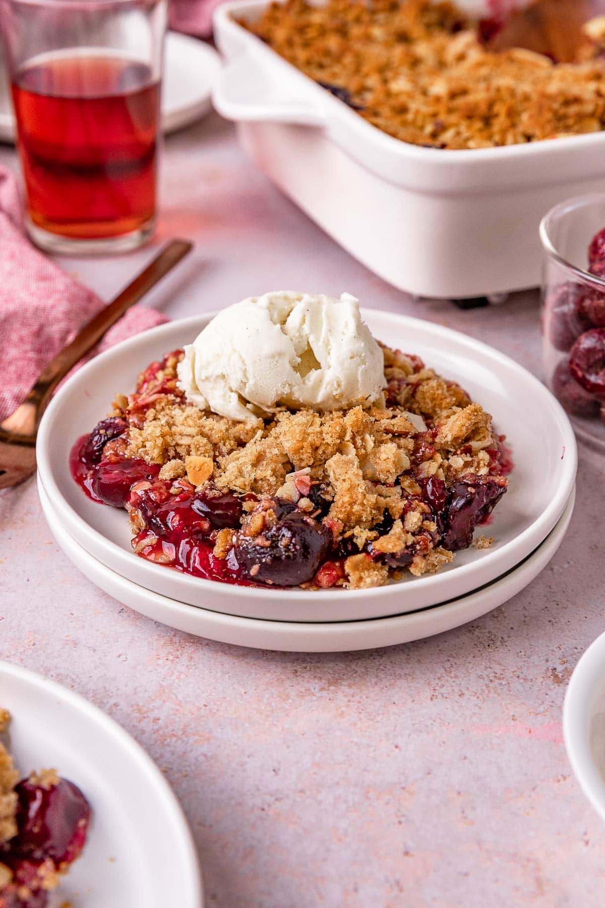 Cherry Crisp prepared and plated with scoop of vanilla ice cream on top