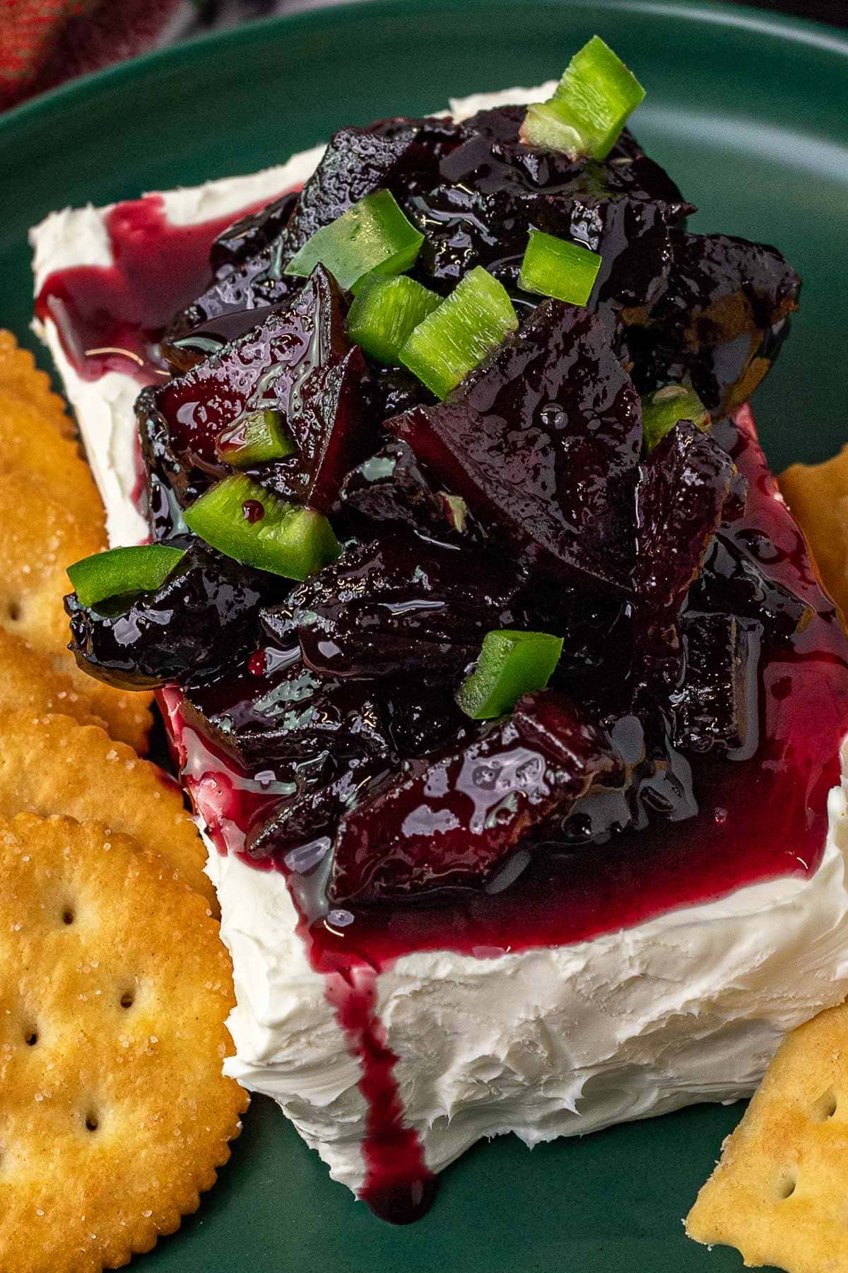 Cherry Jalapeno Jam prepared and served on cream cheese with crackers