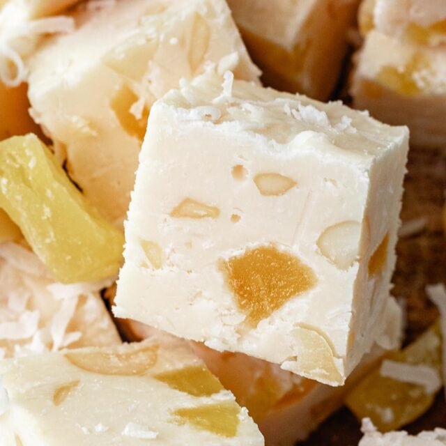 Pina Colada Fudge squares in a pile with close up of one square